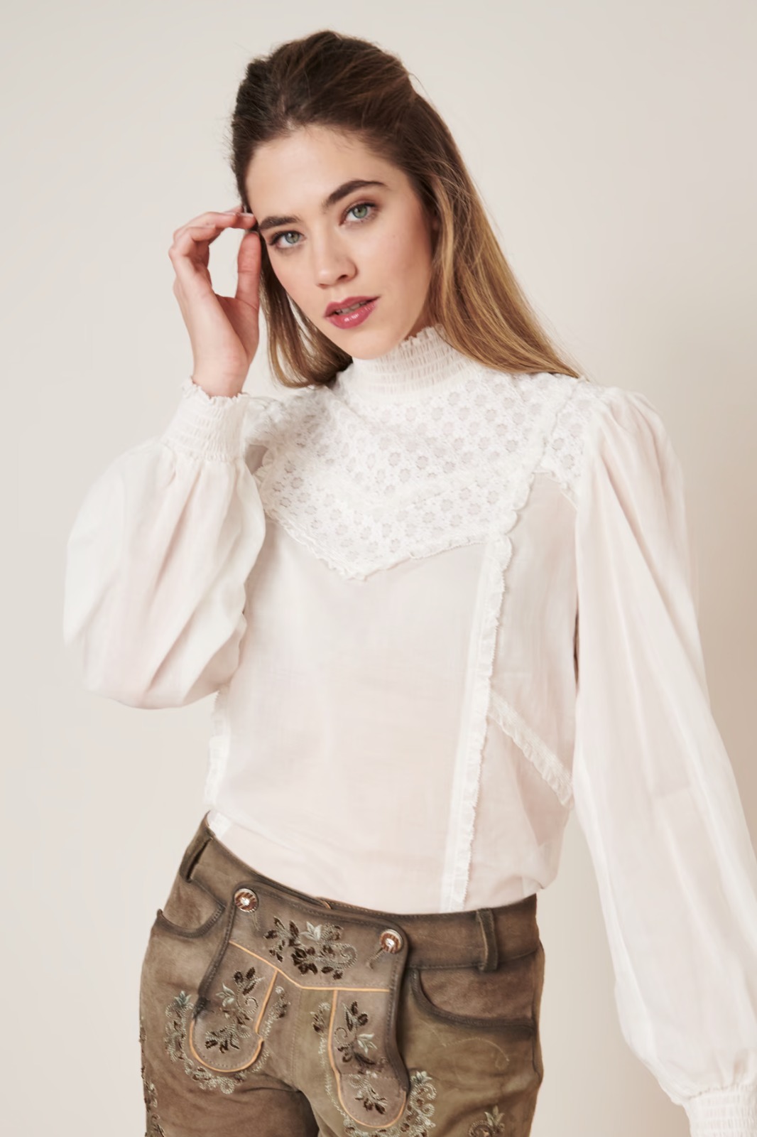 بلوزة نسائية بيضاء بأكمام طويلة وياقة عالية